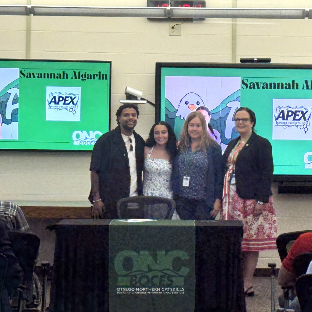 Student stands with parent, ONC BOCES staff member and ONC BOCES district superintendent.