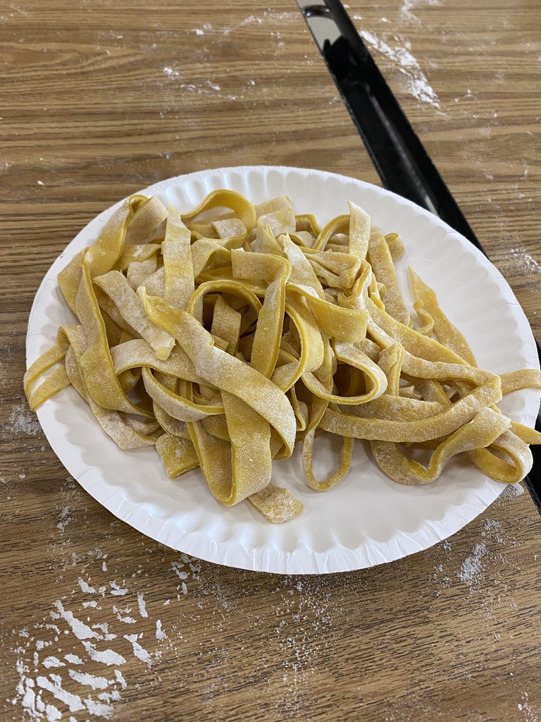 Uncooked pasta noodles on a paper plate