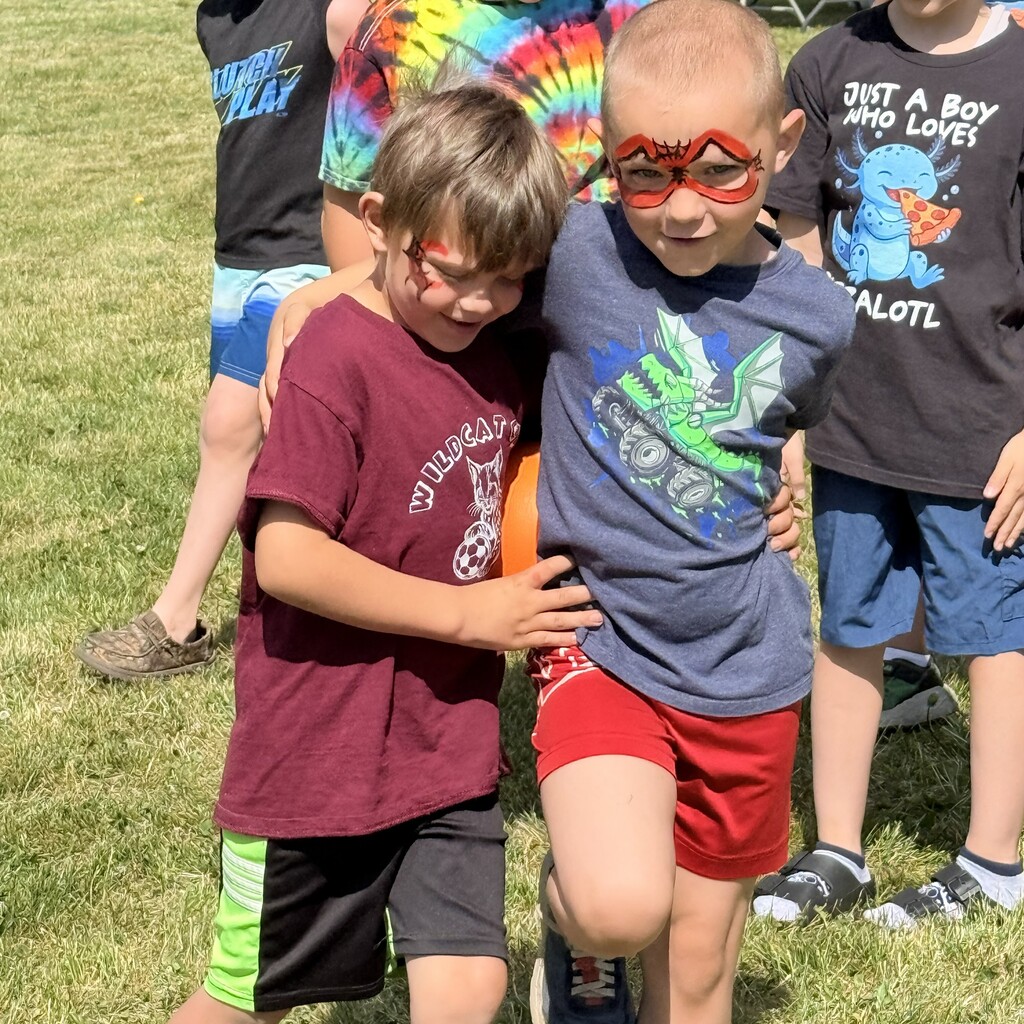 Two elementary students walking together with an arm around each other