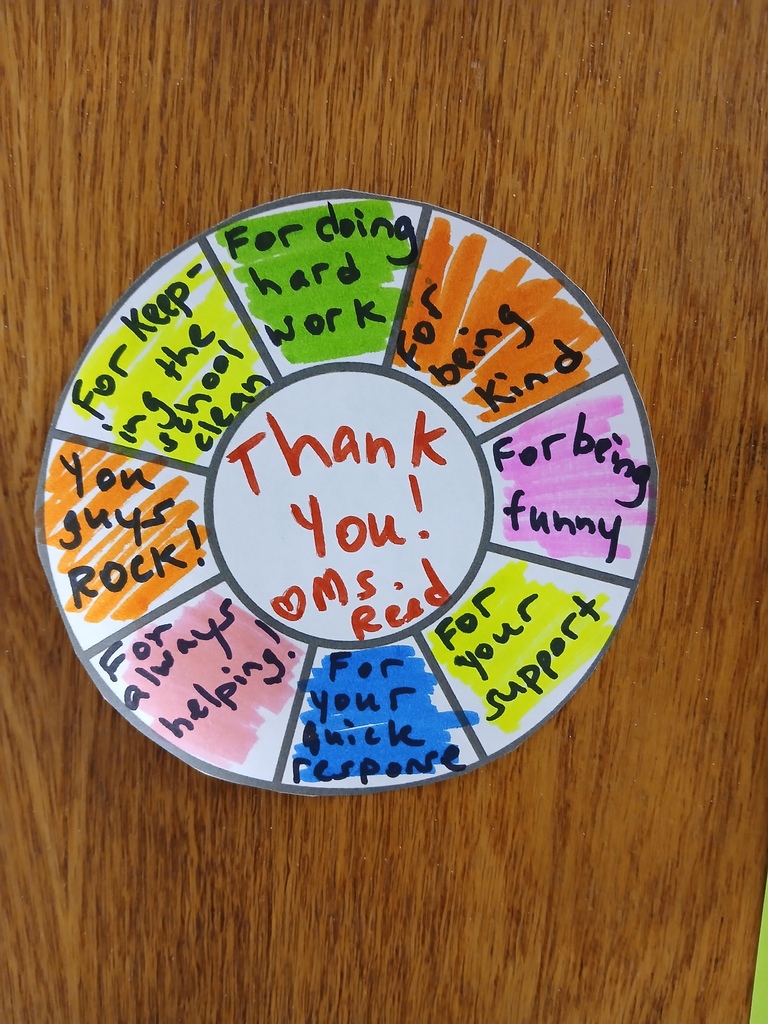 A colored cut-out circle that says Thank you heart Ms. Reed, and also for keeping the school clean, for doing hard work, for being kind, for being funny, for your support, for your quick response, for always helping, you guys rock