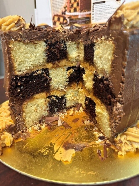 The inside of the cake which is vanilla and chocolate checkerboard pattern