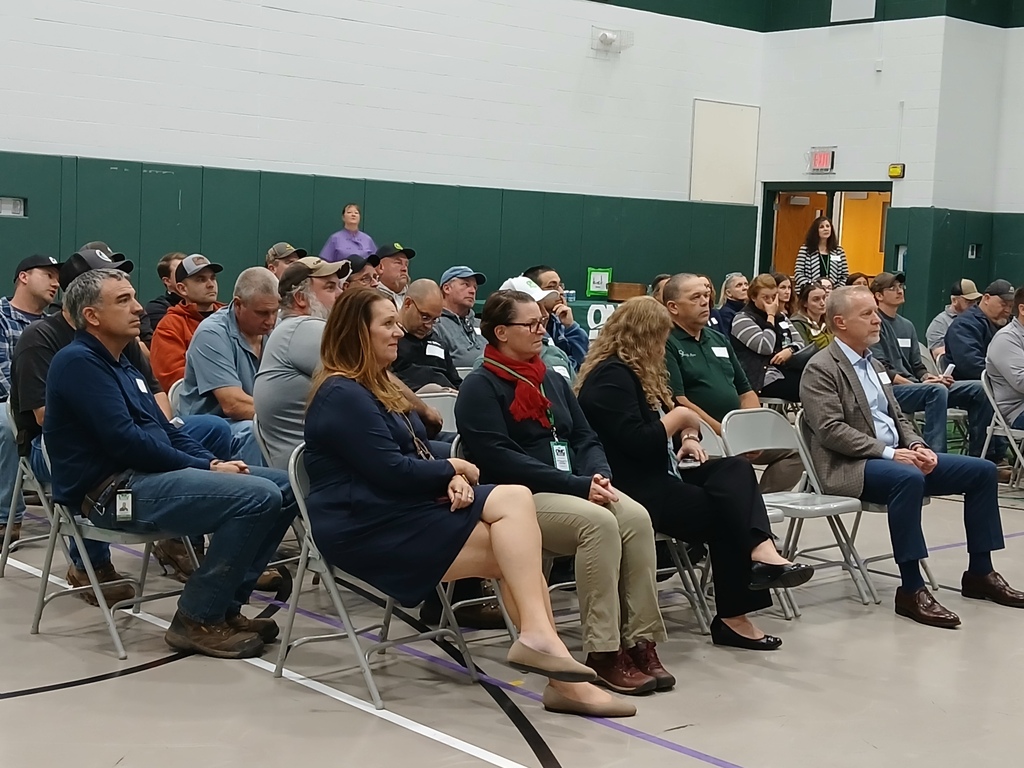 A picture of the guests sitting in chairs and listening to the presenters.