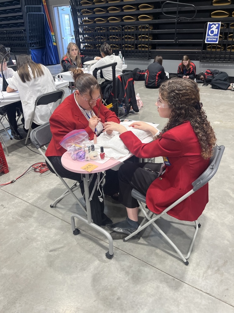 Student painting another student's nails