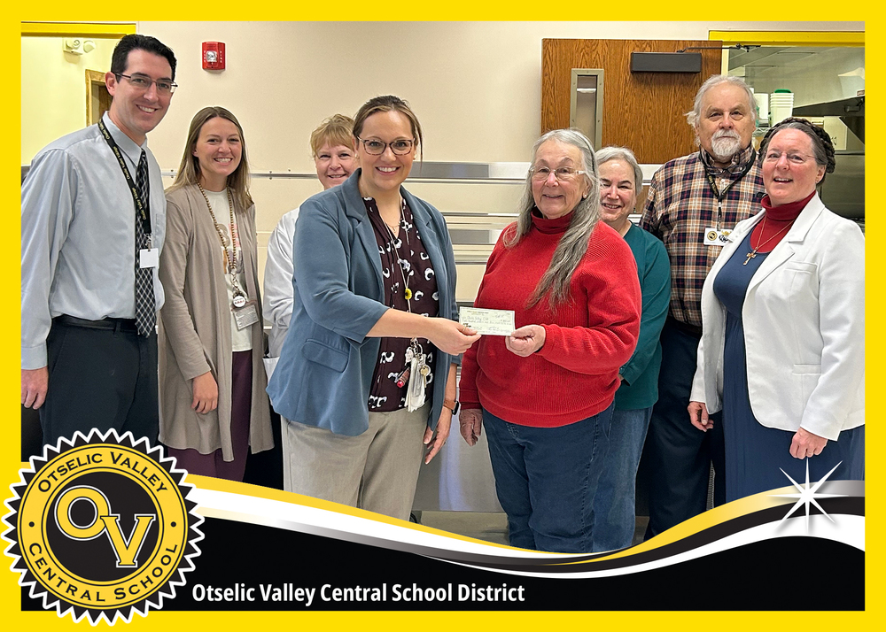 Representatives from local community organizations receive a donation from the Otselic Valley Teachers Association in support of families through the Holiday Basket initiative.