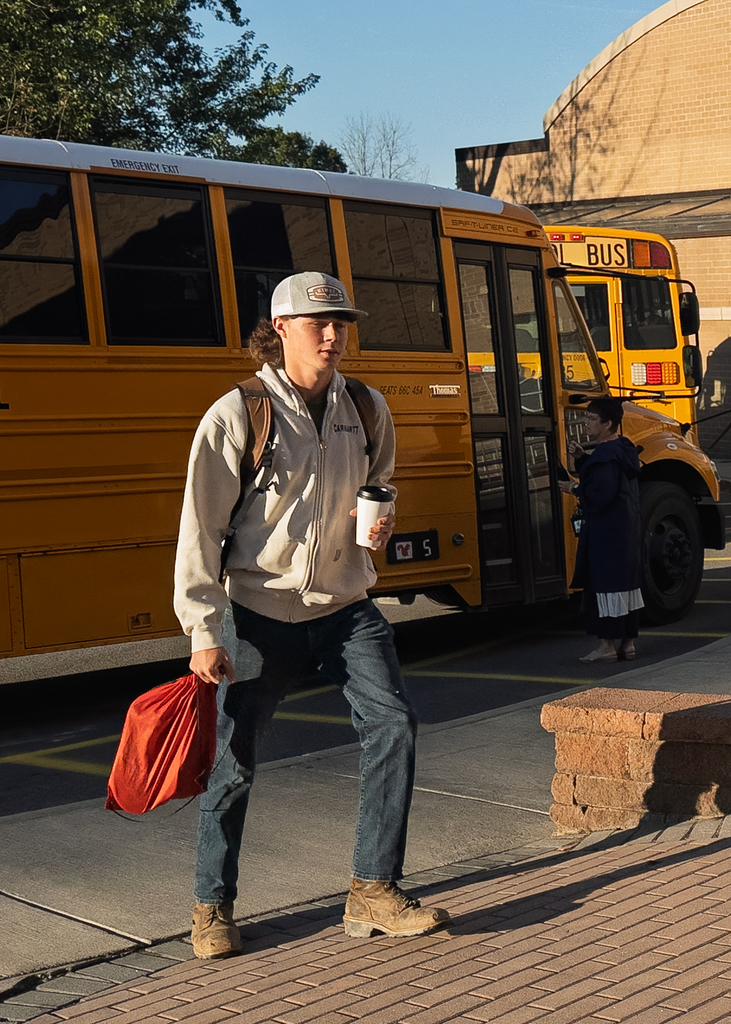 Student walking with coffee