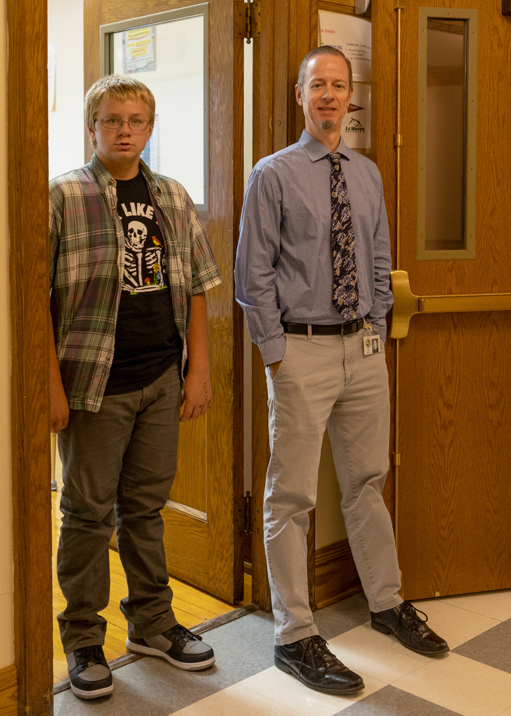 Teacher and student standing in hall