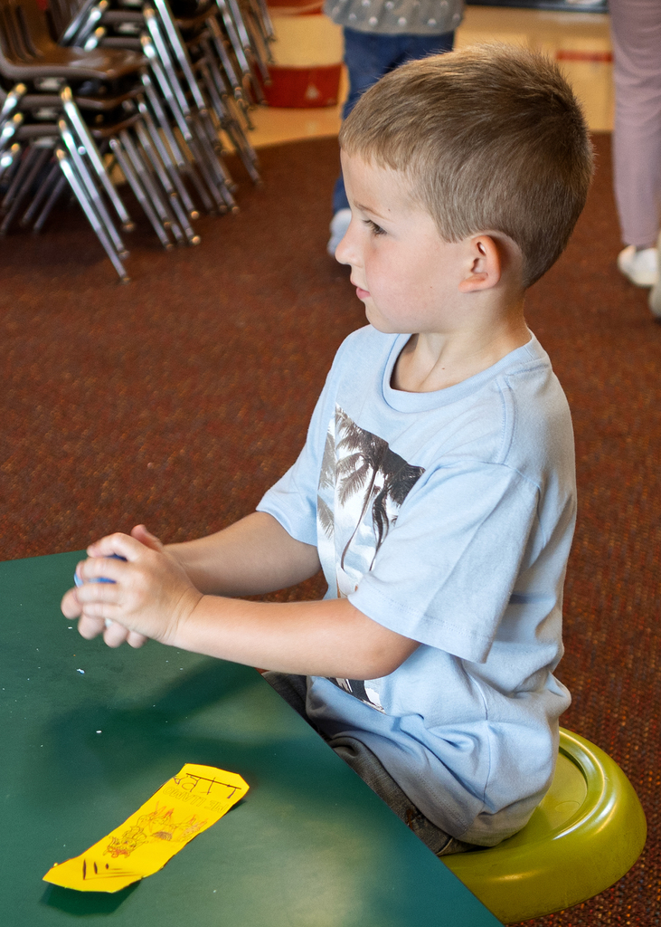 Student working on squeezing the playdough