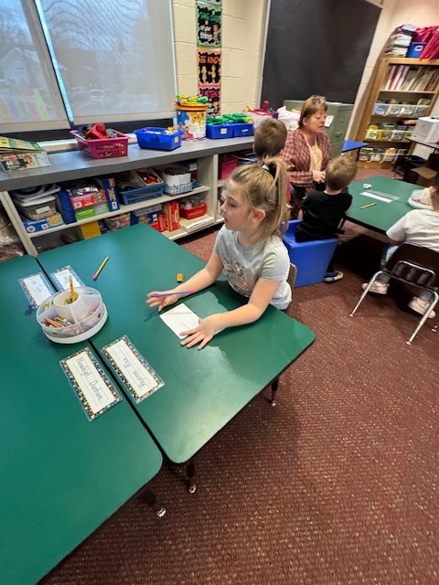 Kindergarten students write out CVC words and play CVC basketball