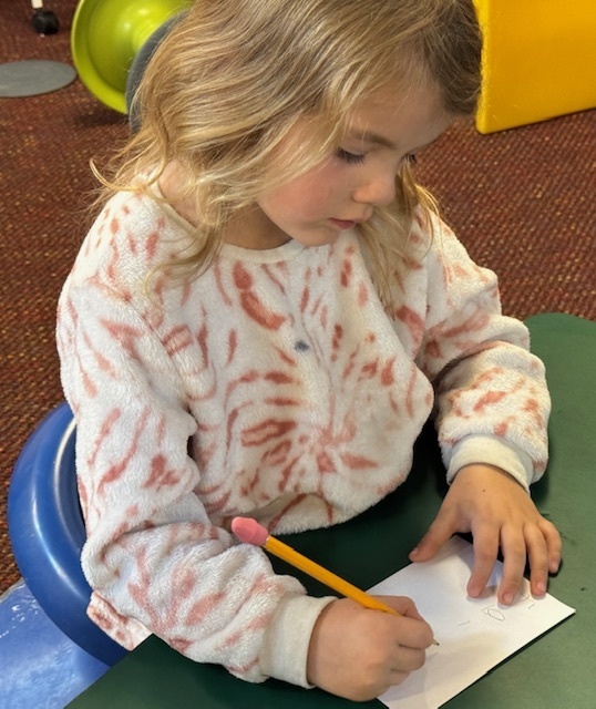 Kindergarten students write out CVC words and play CVC basketball