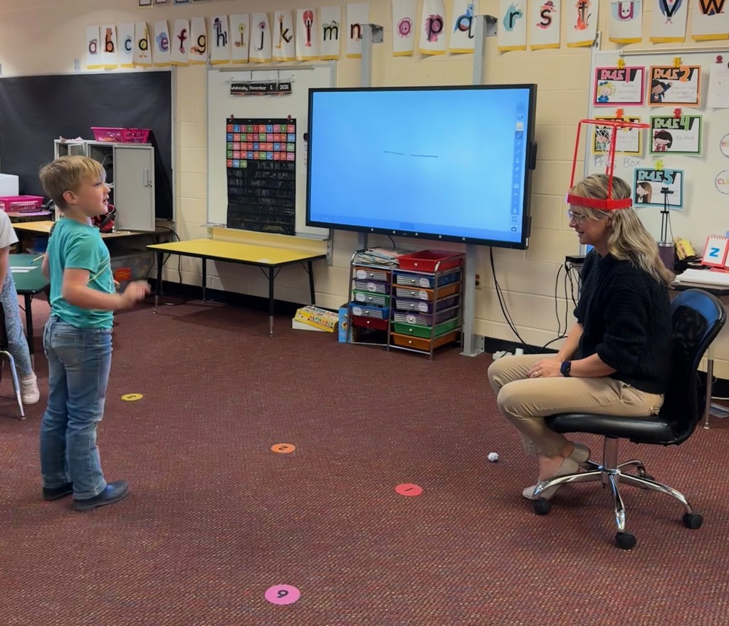 Kindergarten students write out CVC words and play CVC basketball