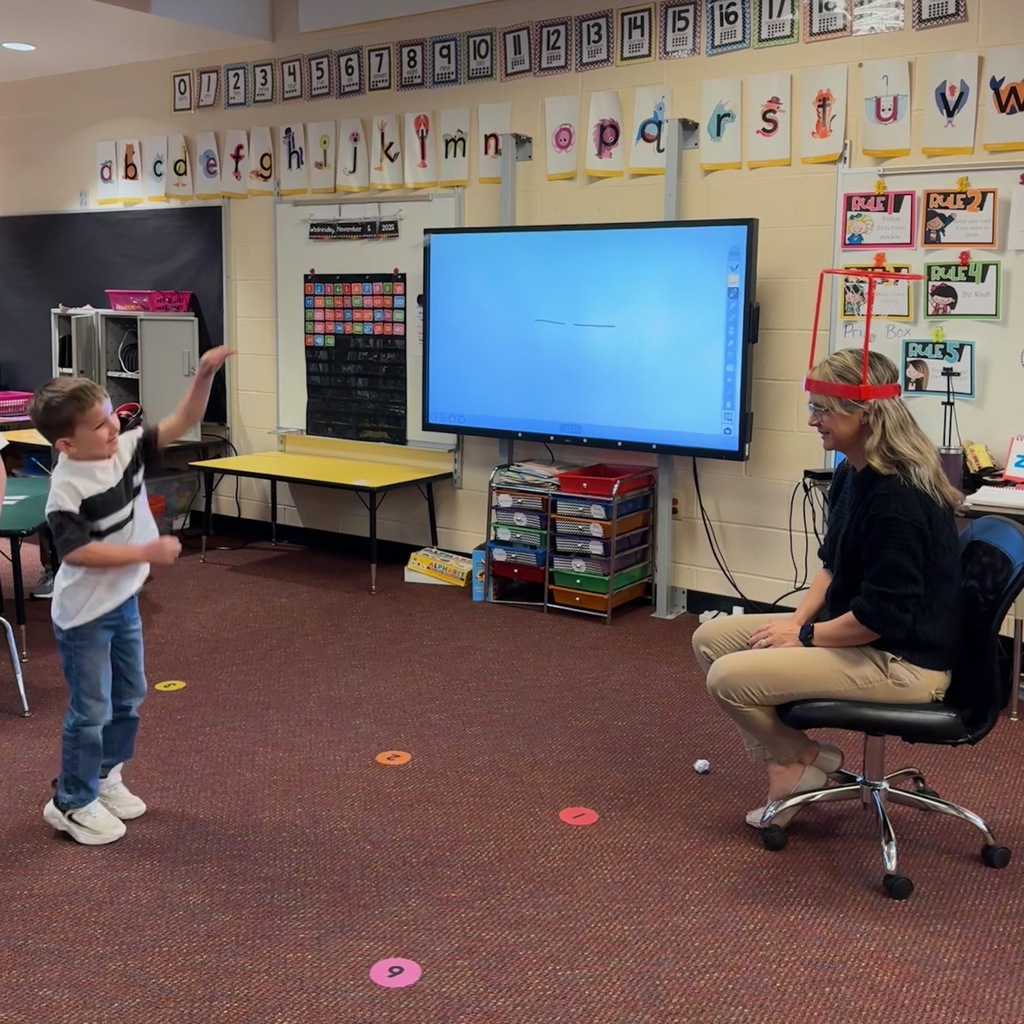 Kindergarten students write out CVC words and play CVC basketball