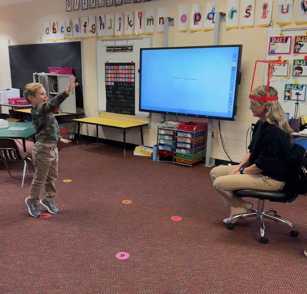 Kindergarten students write out CVC words and play CVC basketball