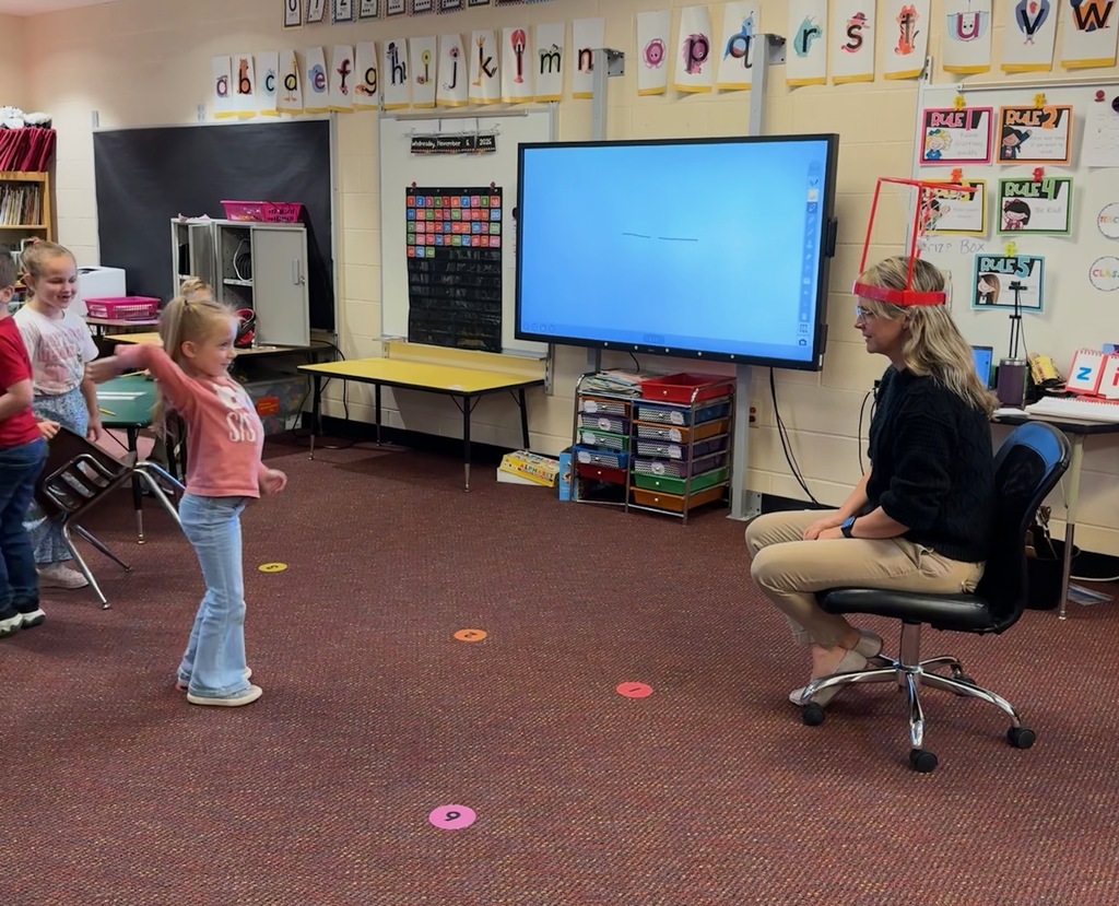 Kindergarten students write out CVC words and play CVC basketball