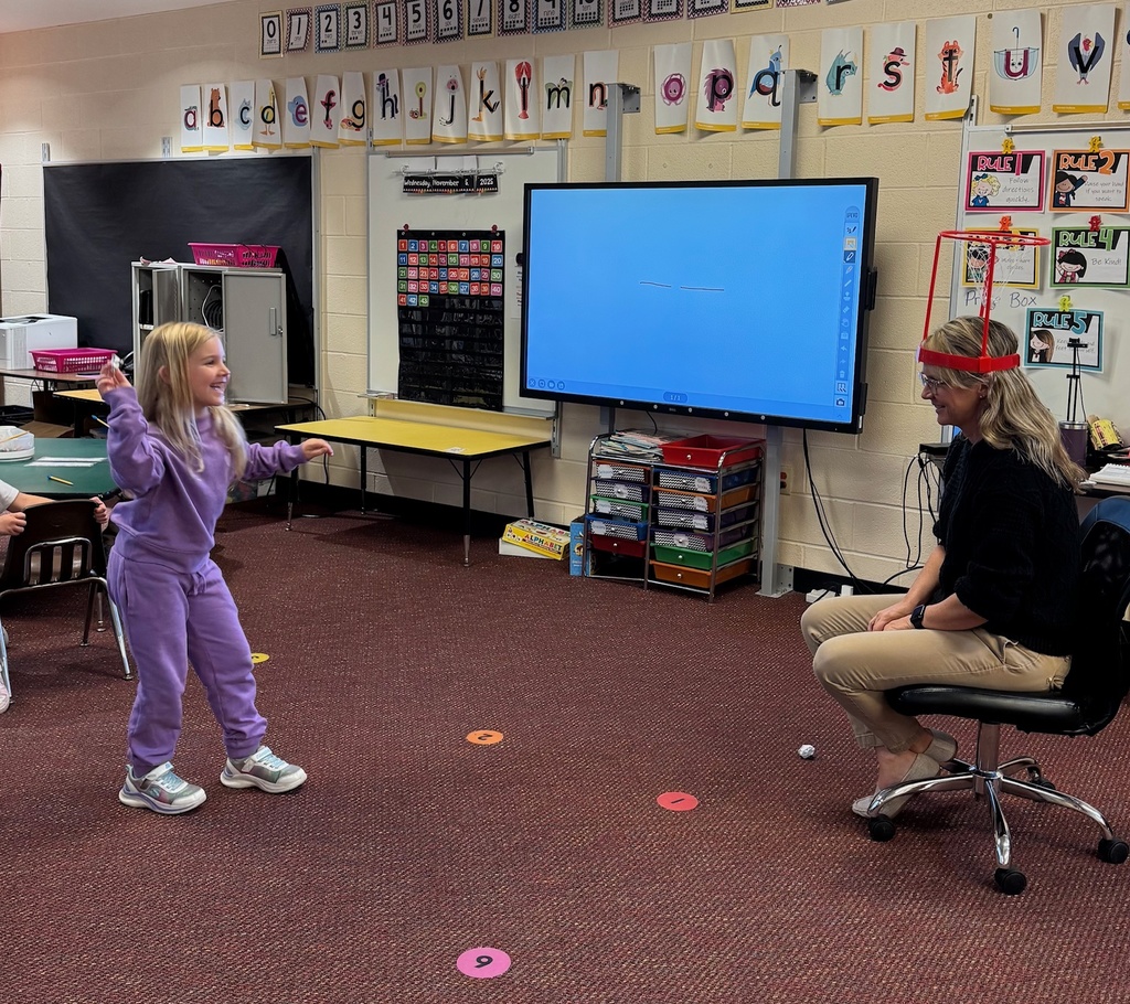Kindergarten students write out CVC words and play CVC basketball