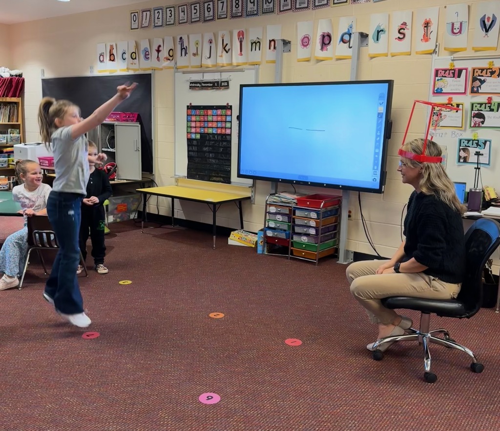 Kindergarten students write out CVC words and play CVC basketball
