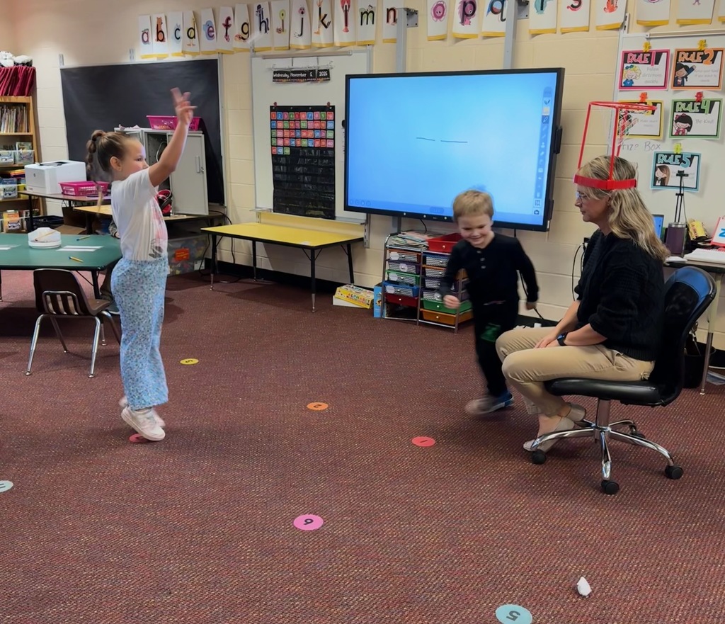 Kindergarten students write out CVC words and play CVC basketball