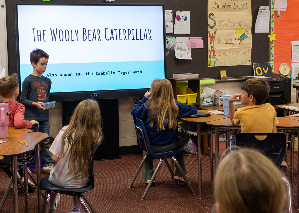 Hudson presents to the class about Willy the Wooly Bear Caterpillar