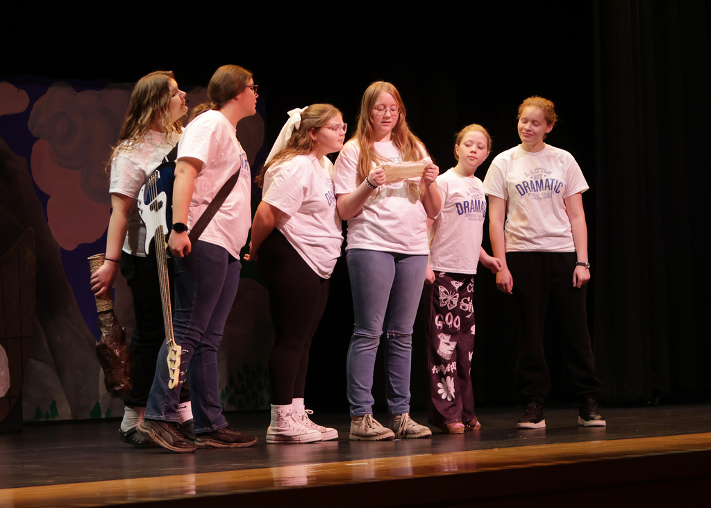 Cast reading a note from a computer
