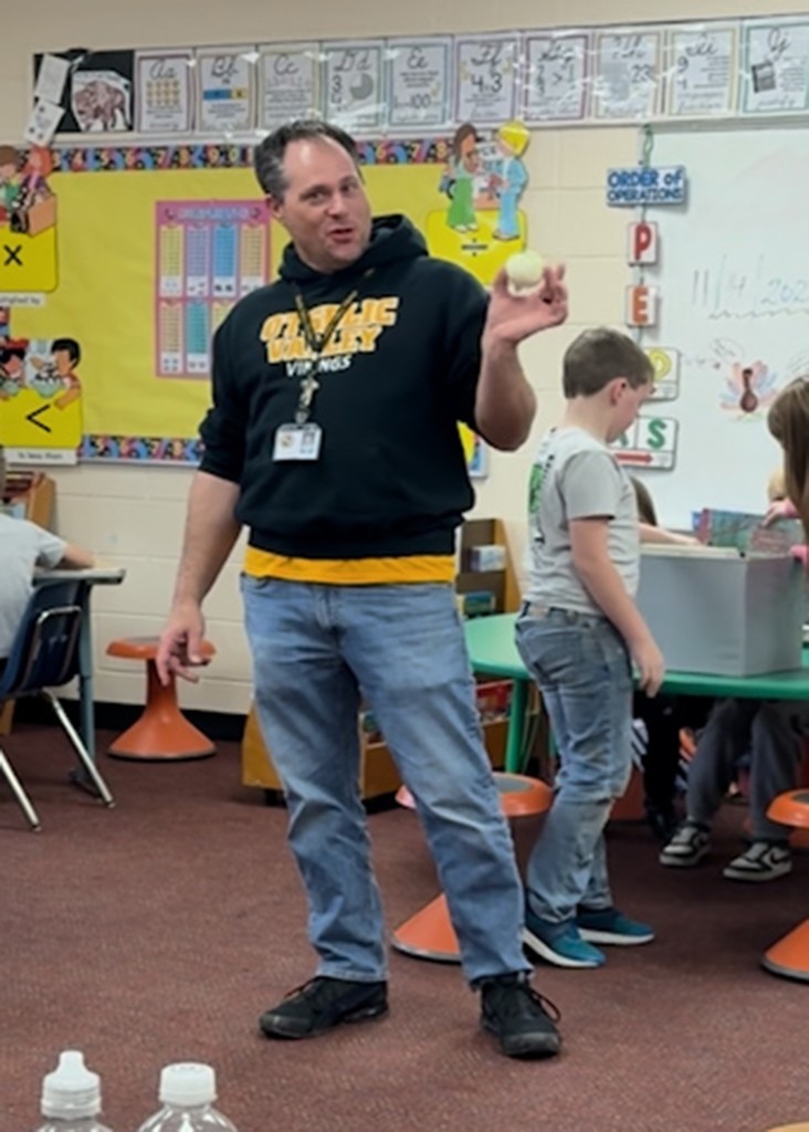 Mr. Gross showing the class the onion