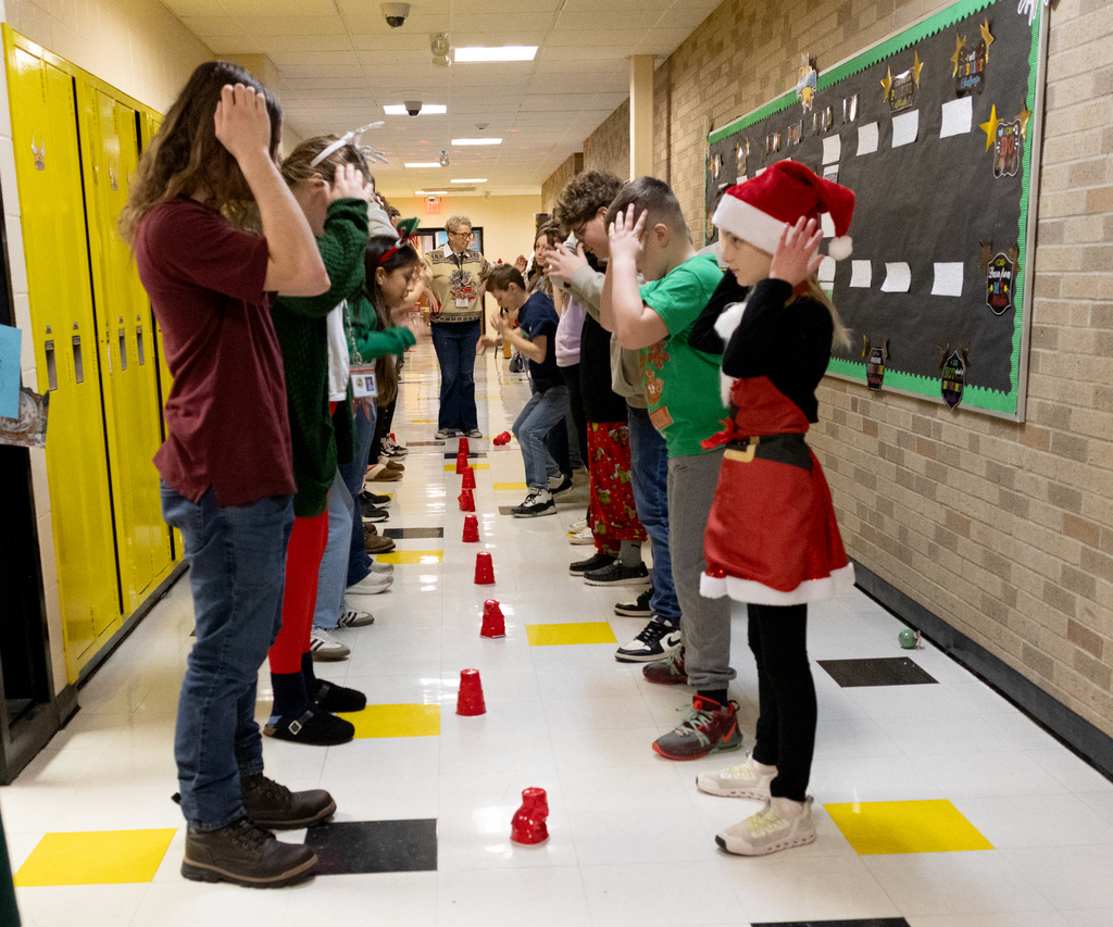 OV students play the cup game after making ornaments
