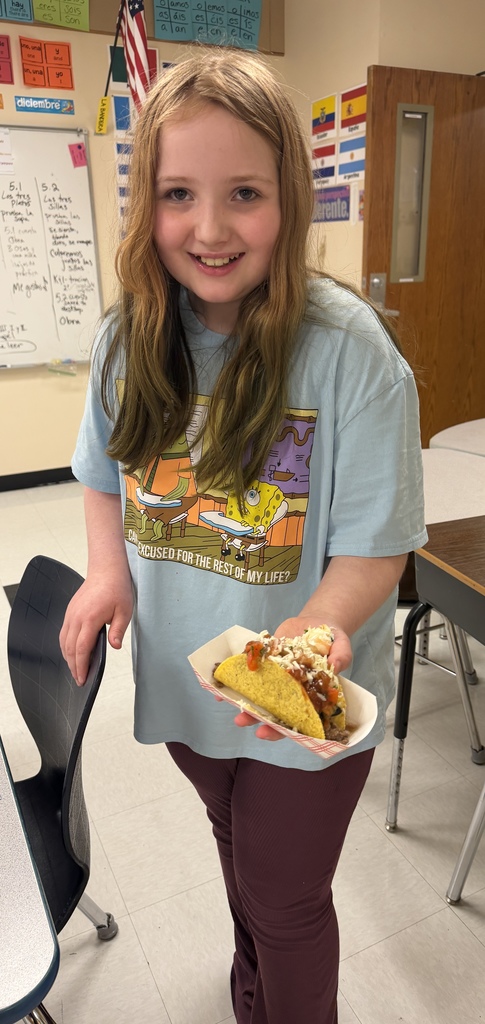 Student showing off her taco she made