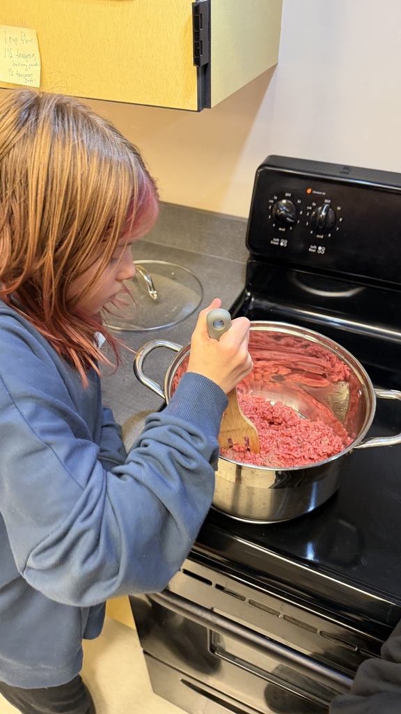 Student starting to make tacos on the stovetop