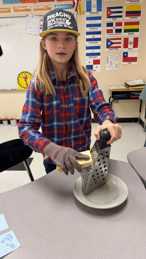 Student shredding cheese