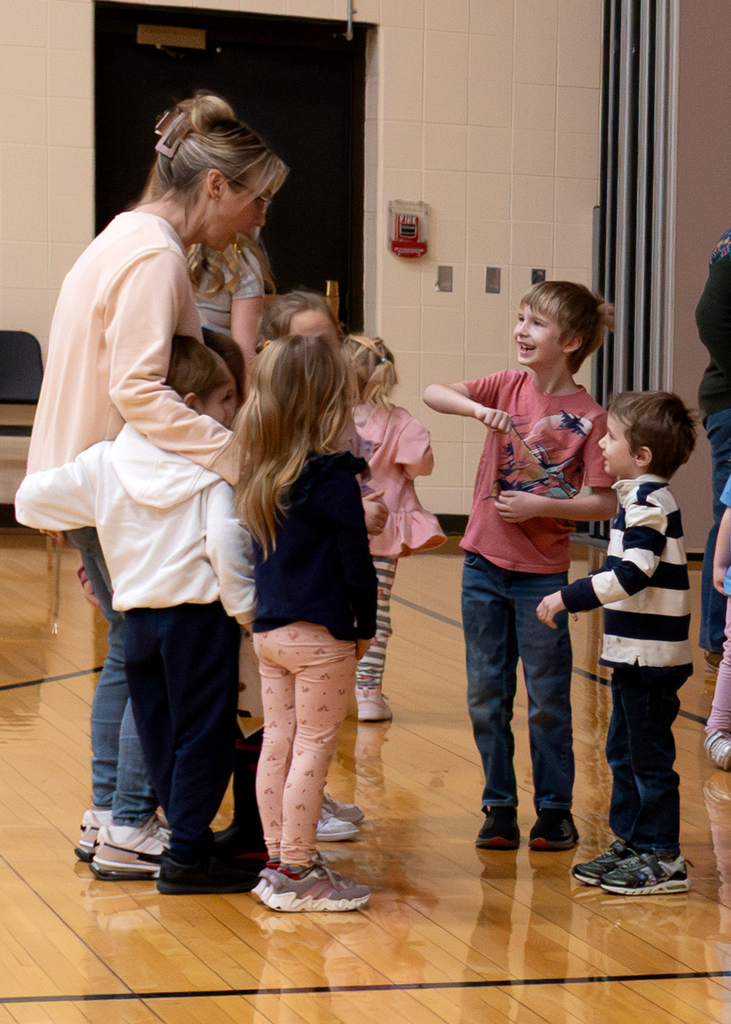 A teacher and students dancing