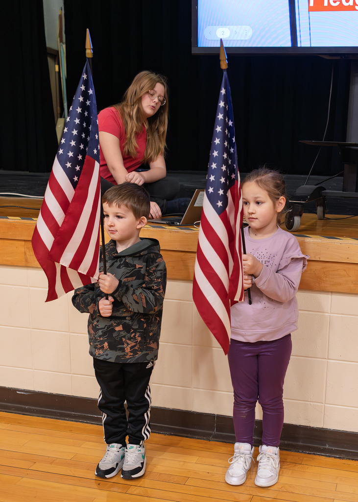 Flag bearers standing in front of the stage