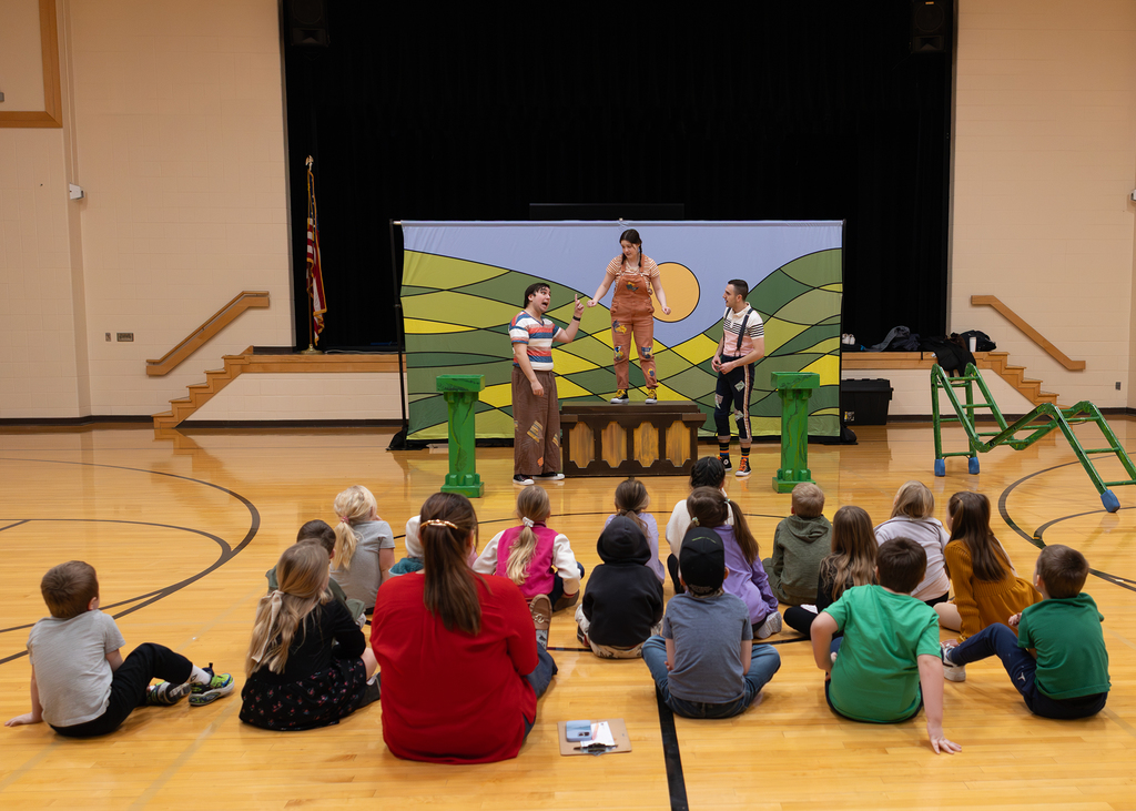 The REV Theatre starts their performance with the first graders looking on