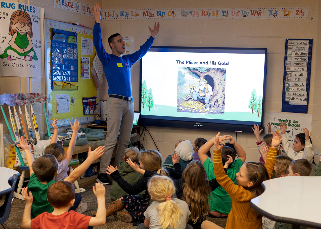A cast member helps students learn about fables and parables in the classroom