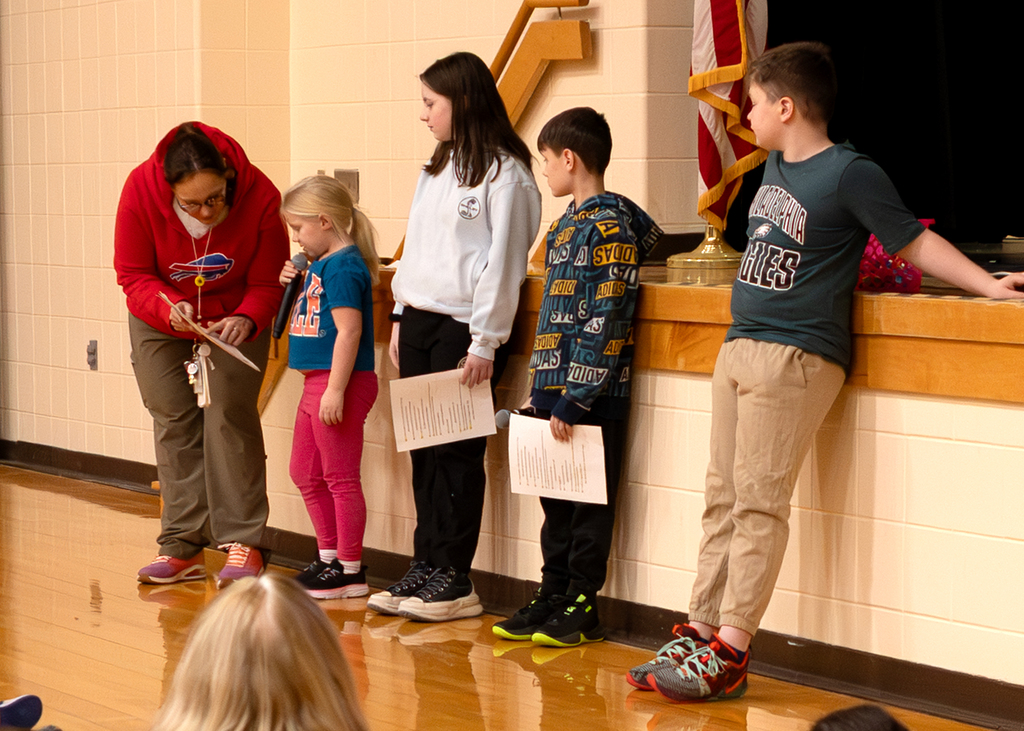 A student shares the lunch menu at Morning Program