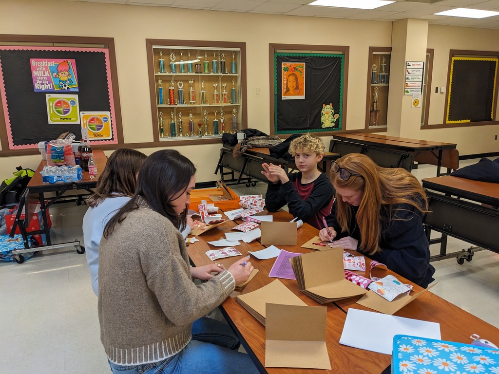 LPP students and Colgate mentors sit at a table and make cards