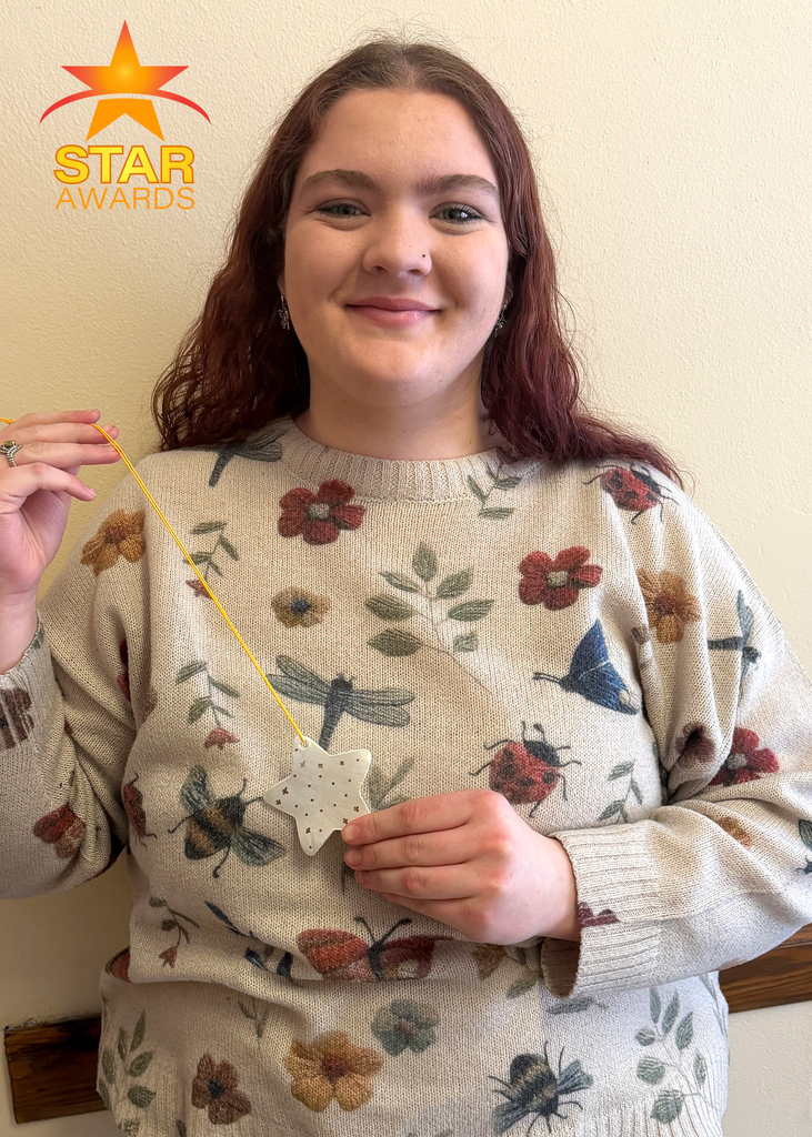 One January student award winner standing in the hall