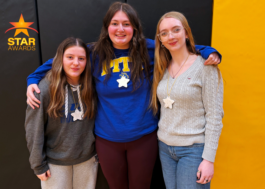 Three January star award winners standing in the gym