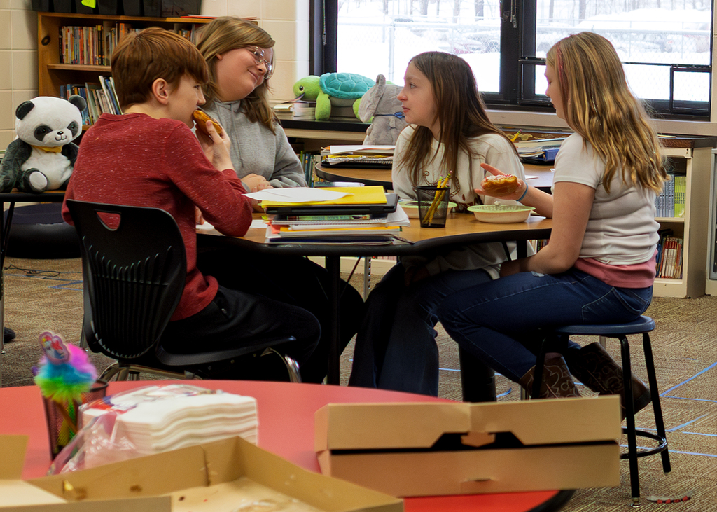 5th grade students sitting at a table