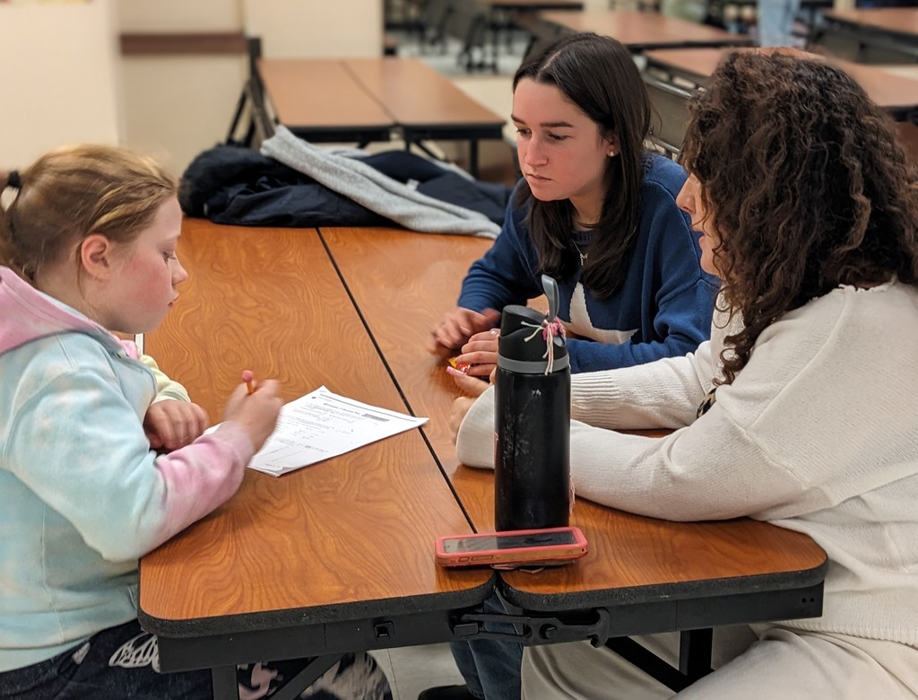 OV LPP students and Colgate mentors work together on activities at a table.