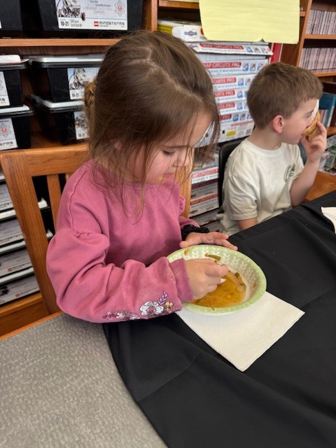 A student trying the soup