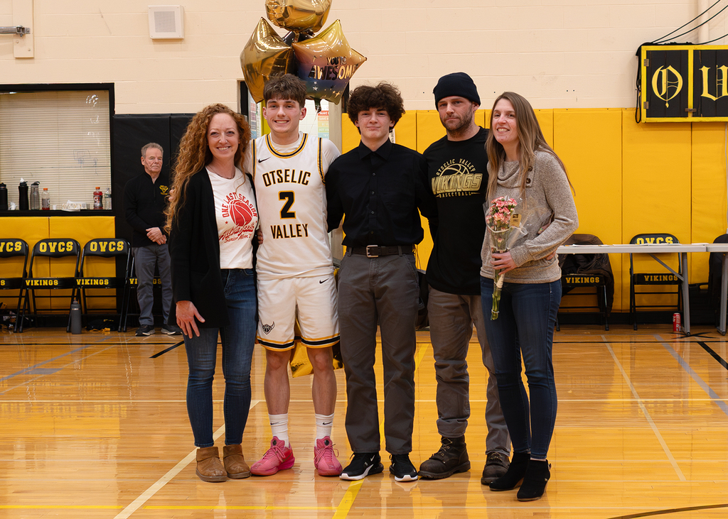 A senior with his family in the gym
