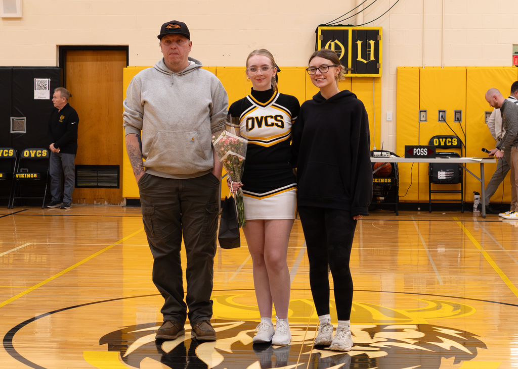 A senior with her family in the gym