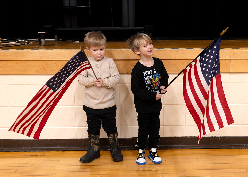 Flag bearers standing in front of the stage