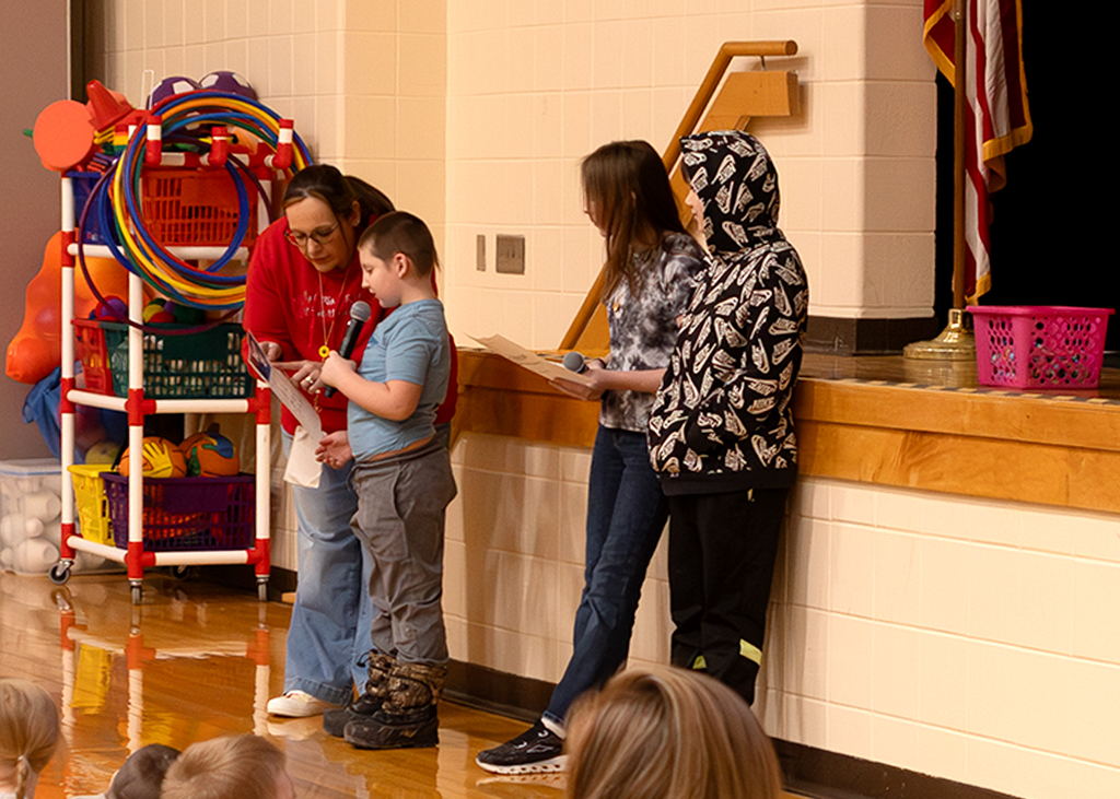 A student shares the lunch menu at Morning Program