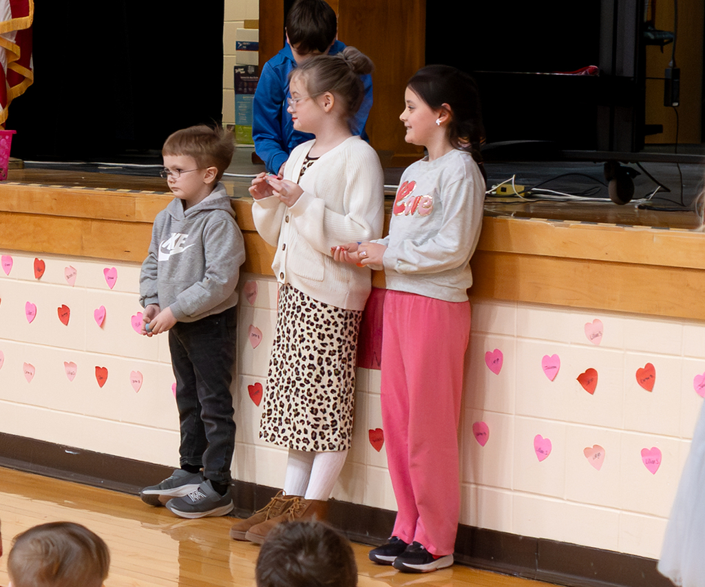 Students standing in front of the stage