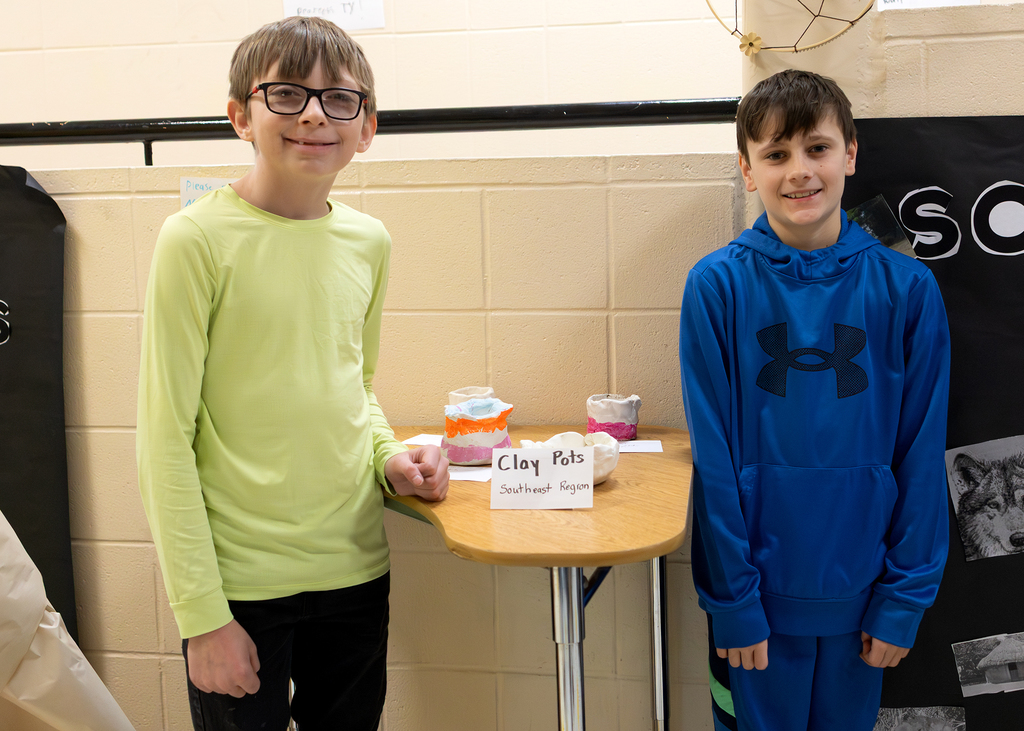 Two students pose with their projects