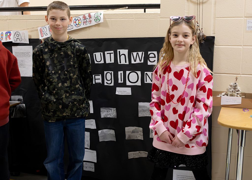 Two students pose with their poster