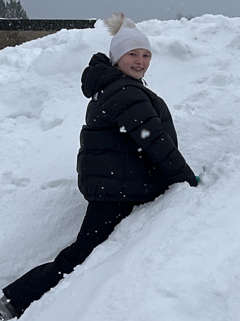 A student playing in the snow