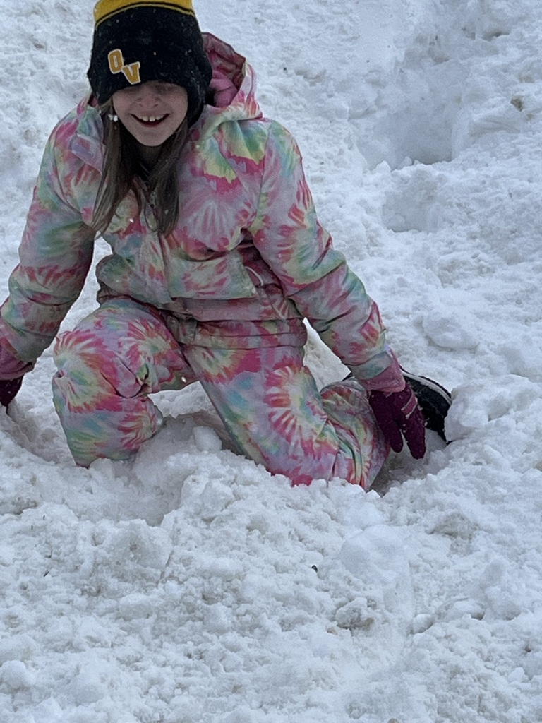 A student playing in the snow
