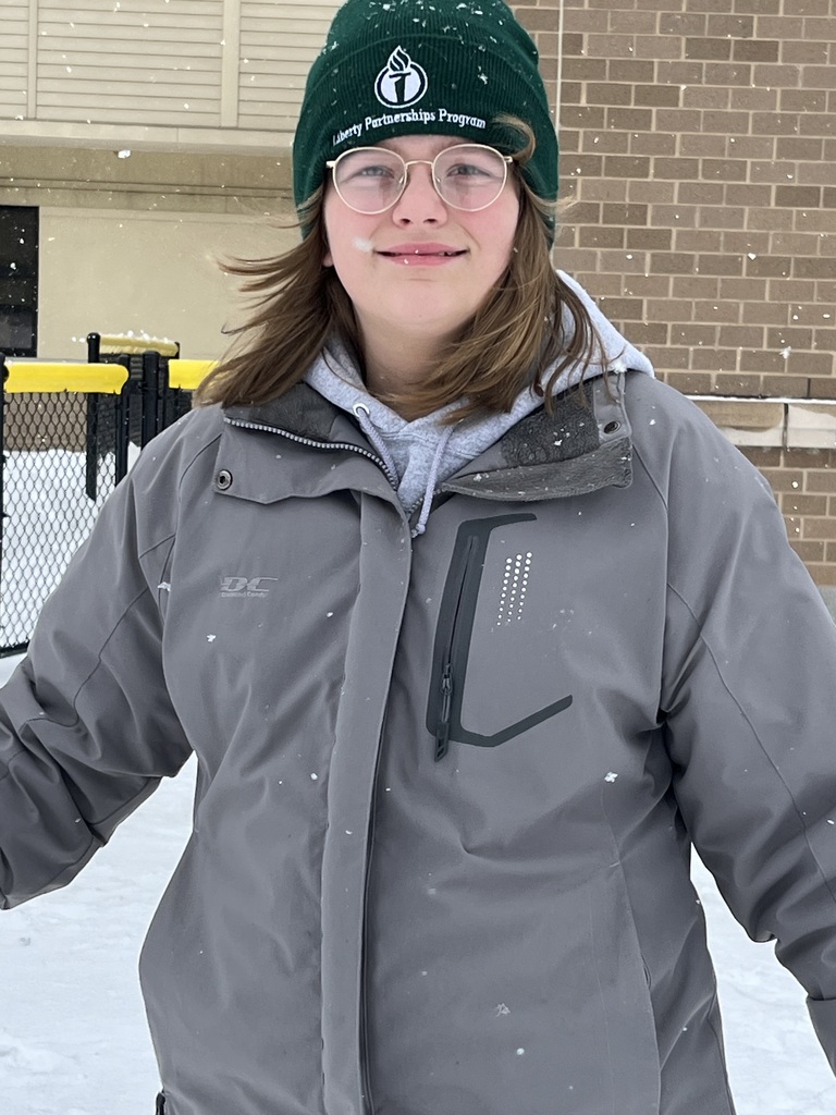 A student playing in the snow