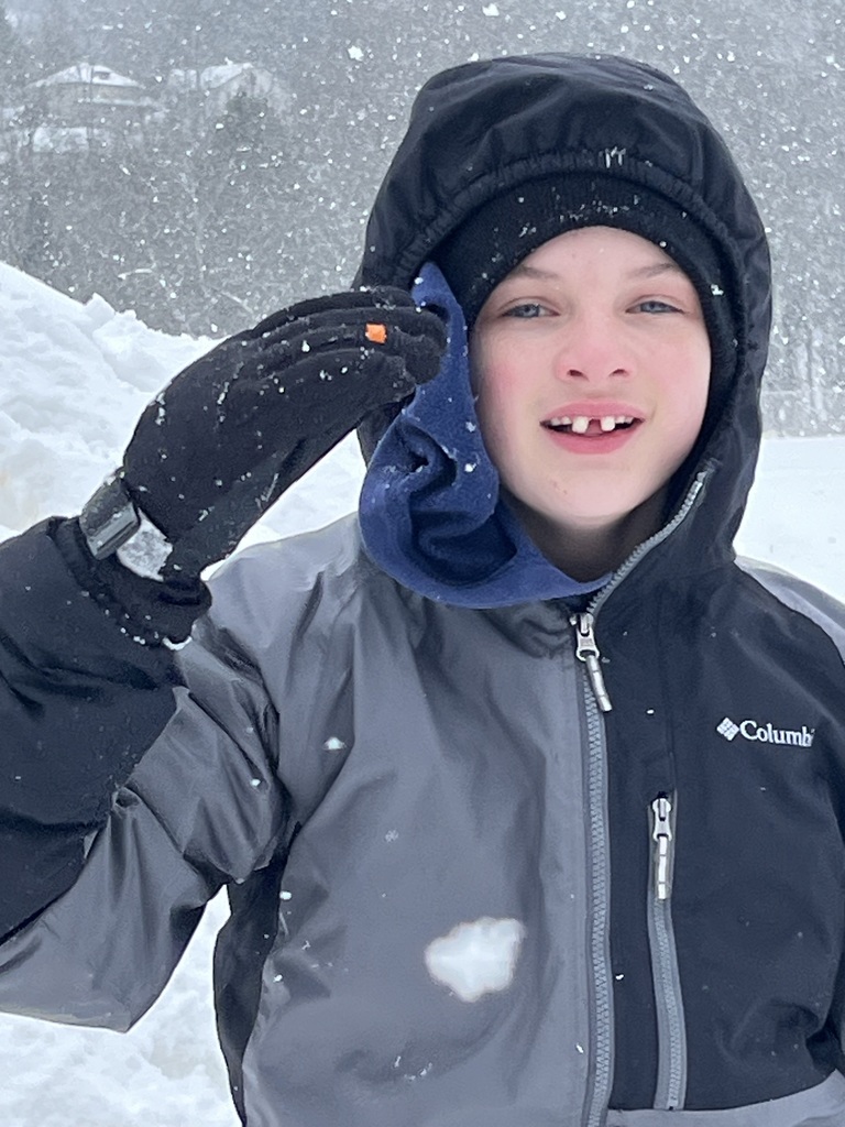 A student playing in the snow