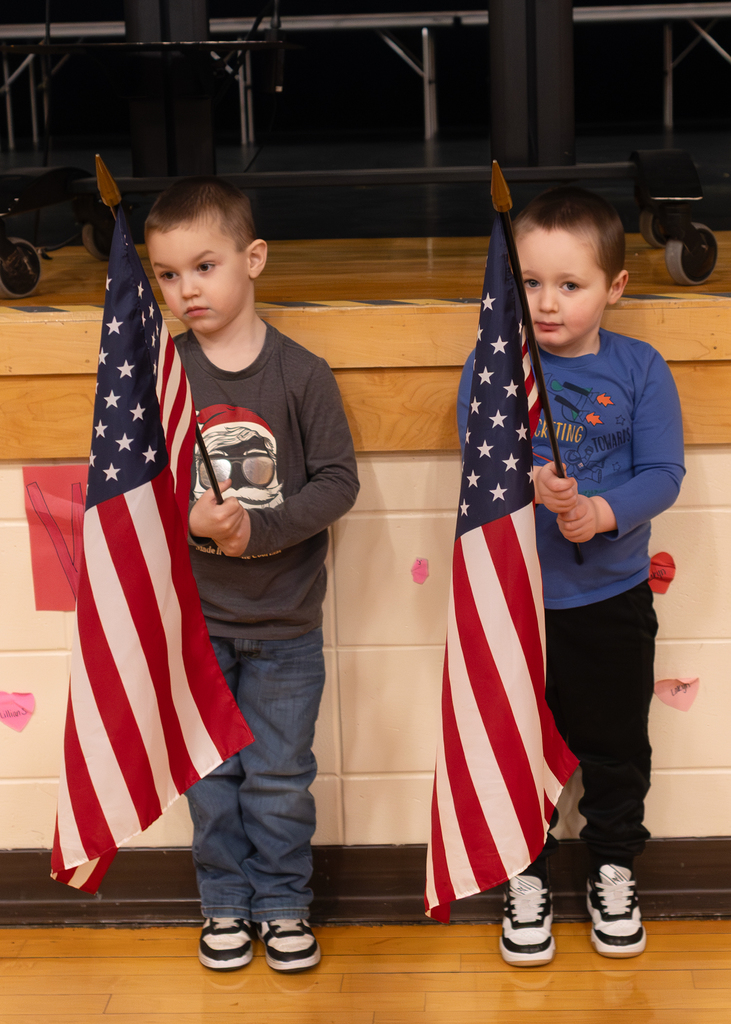 Flag bearers standing in front of the stage